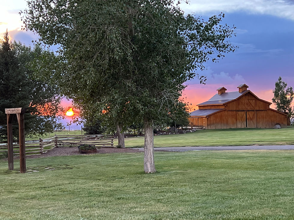 Grand Junction wedding venue with spacious lawn area and sun setting in the horizon