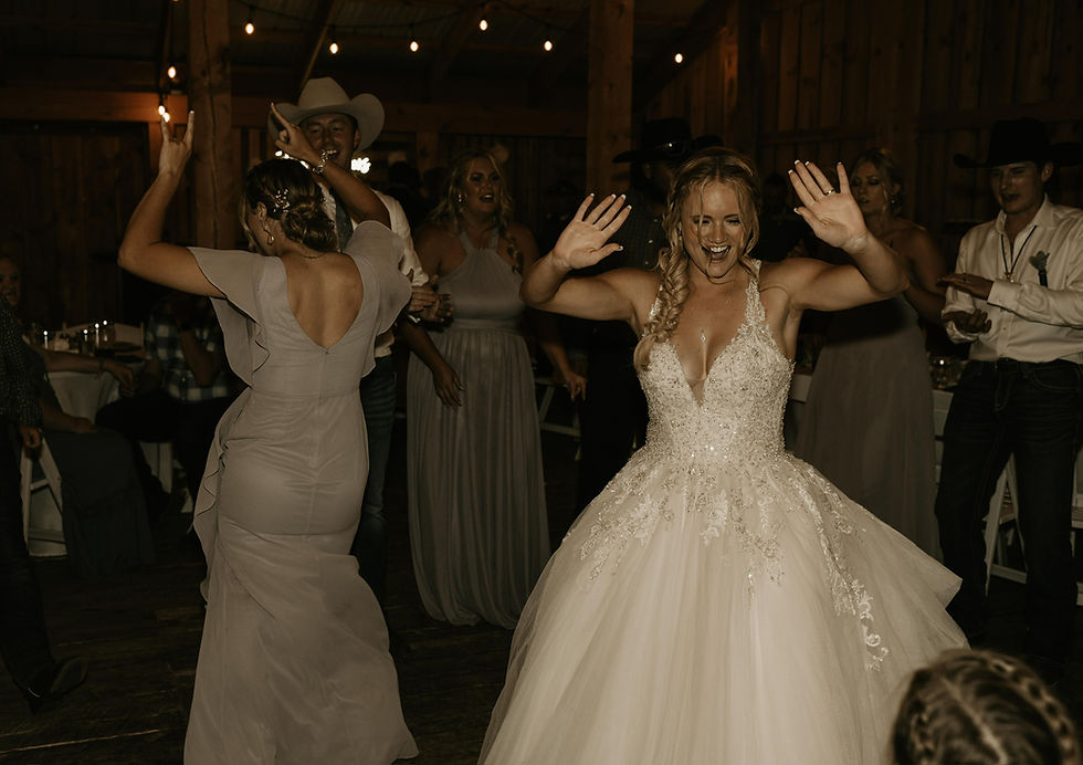 Delta Colorado Bride wearing a 2025 trending wedding dress. Bridal gown has the low neckline that is trending for 2025. Colorado barn wedding indoor reception located near Delta, Colorado