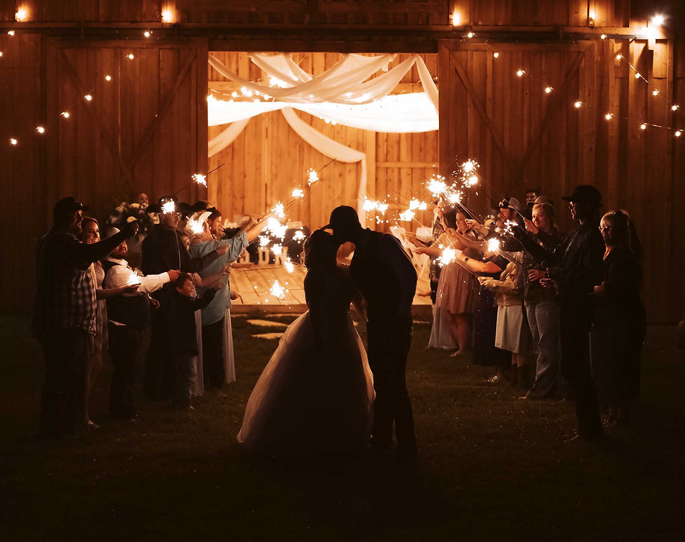 Bride and Groom kissing in front of rustic wedding barn in South Western Colorado