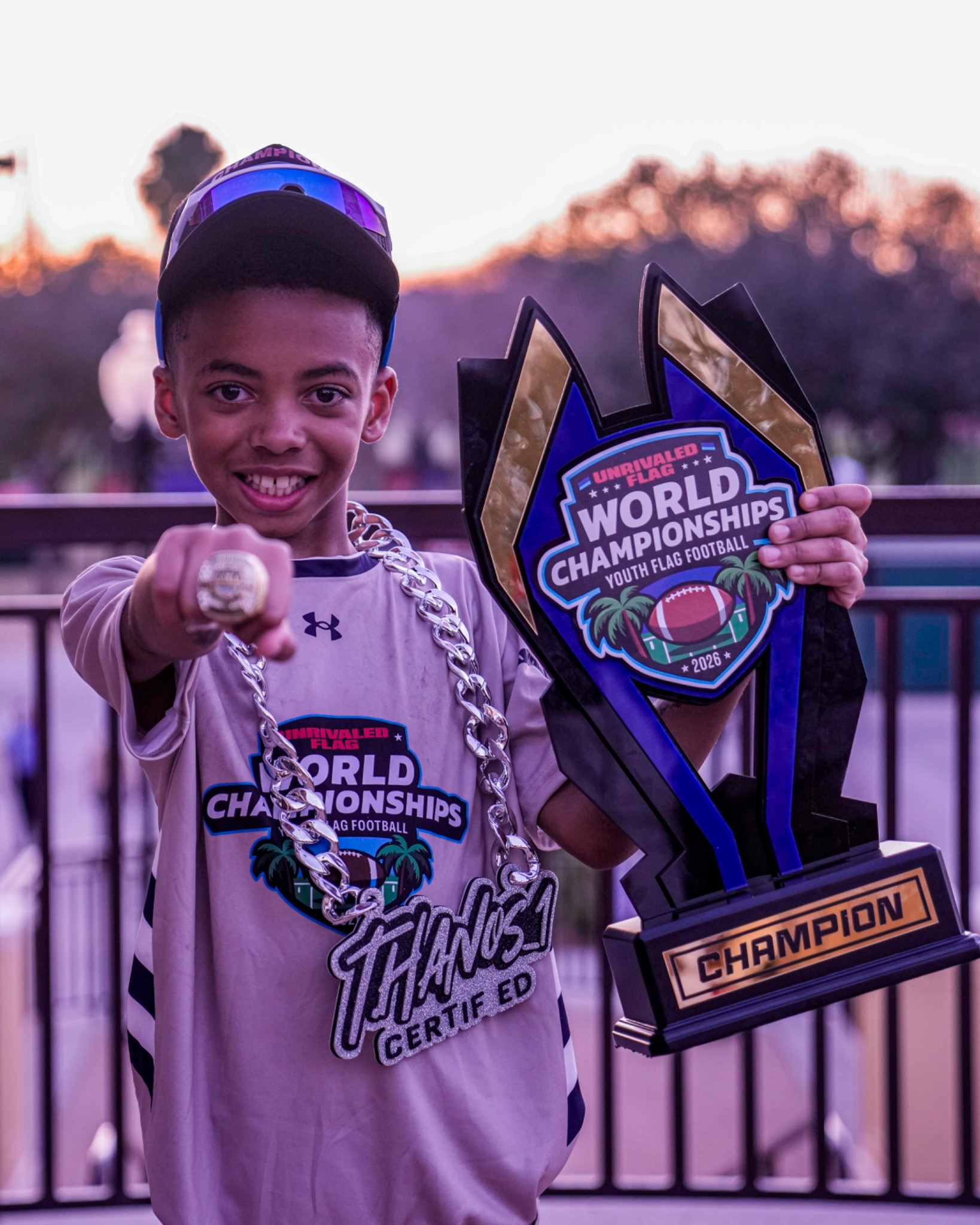 32 Sports athlete with his championship ring and trophy