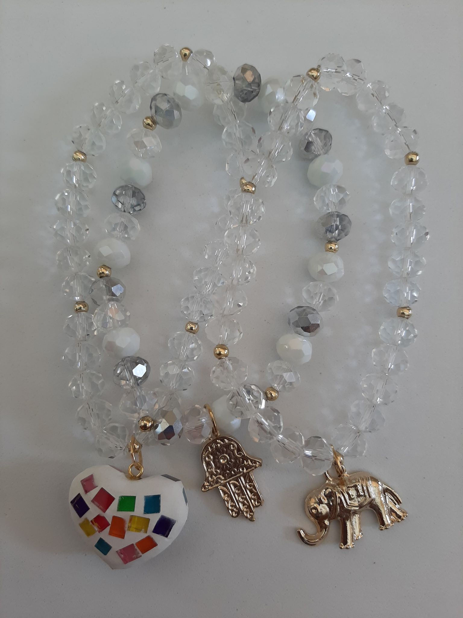 3 transparent and white bracelets with charms
