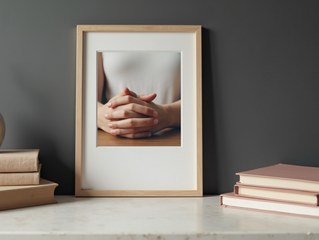 Framed photo of hands over heart on a quiet table, symbolising emotional safety and clarity after collapse