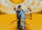 Illustration of two people embracing while one has arrows in their back, representing trauma bonding, emotional pain, and the difficulty of leaving a harmful or abusive relationship.  