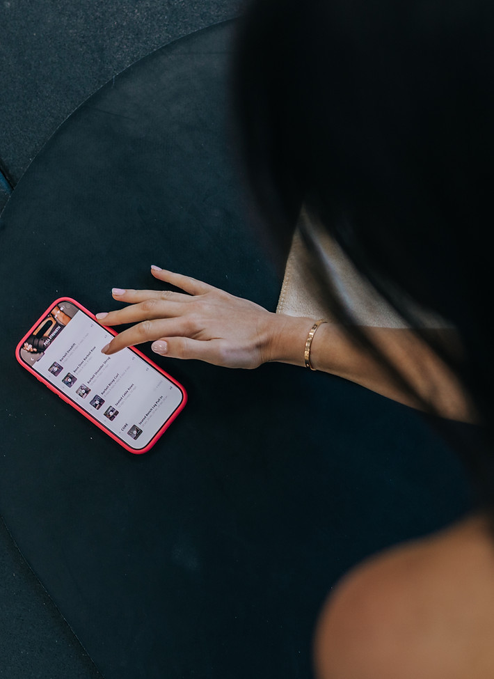Woman checking fitness app for premium wellness program
