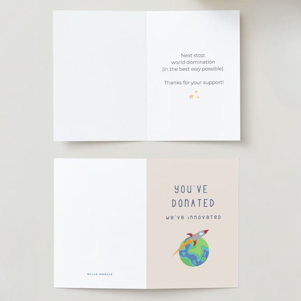 Thumbnail: Front and back of a thank you card with a graphic of the earth and a rocket ship, laying flat on a white surface