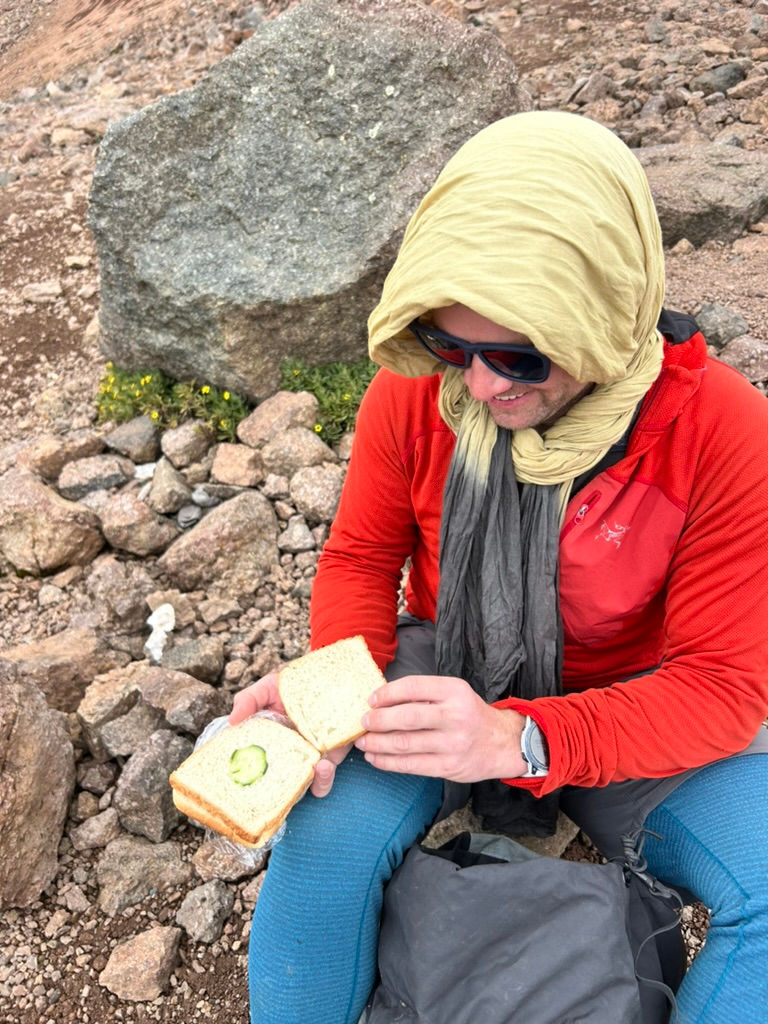 An extremely rare cold lunch and one of the saddest sandwiches I ever did see. Ryan, laughing, and making the most of it. I would call him babooshka because of his headress during this trip.