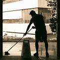 Man cleans floor at an entrance door_edi