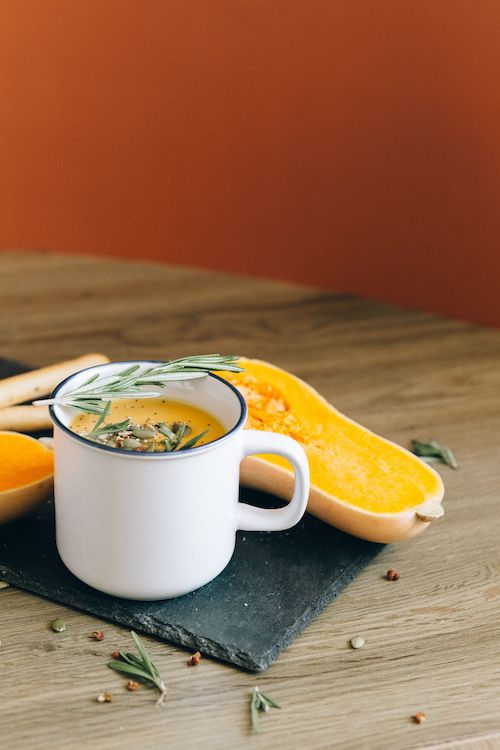 Soupe de courge servie dans une tasse blanche, accord végétarien de L'Élégance du Domaine de La Garnaudière