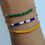 Thumbnail: A set of three bracelets, one green, one yellow, and one blue/white to represent the IDF, the hostages, and the state of Israel