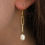 Thumbnail: hook style earring posts with two gold chain links and a dangling freshwater pearl