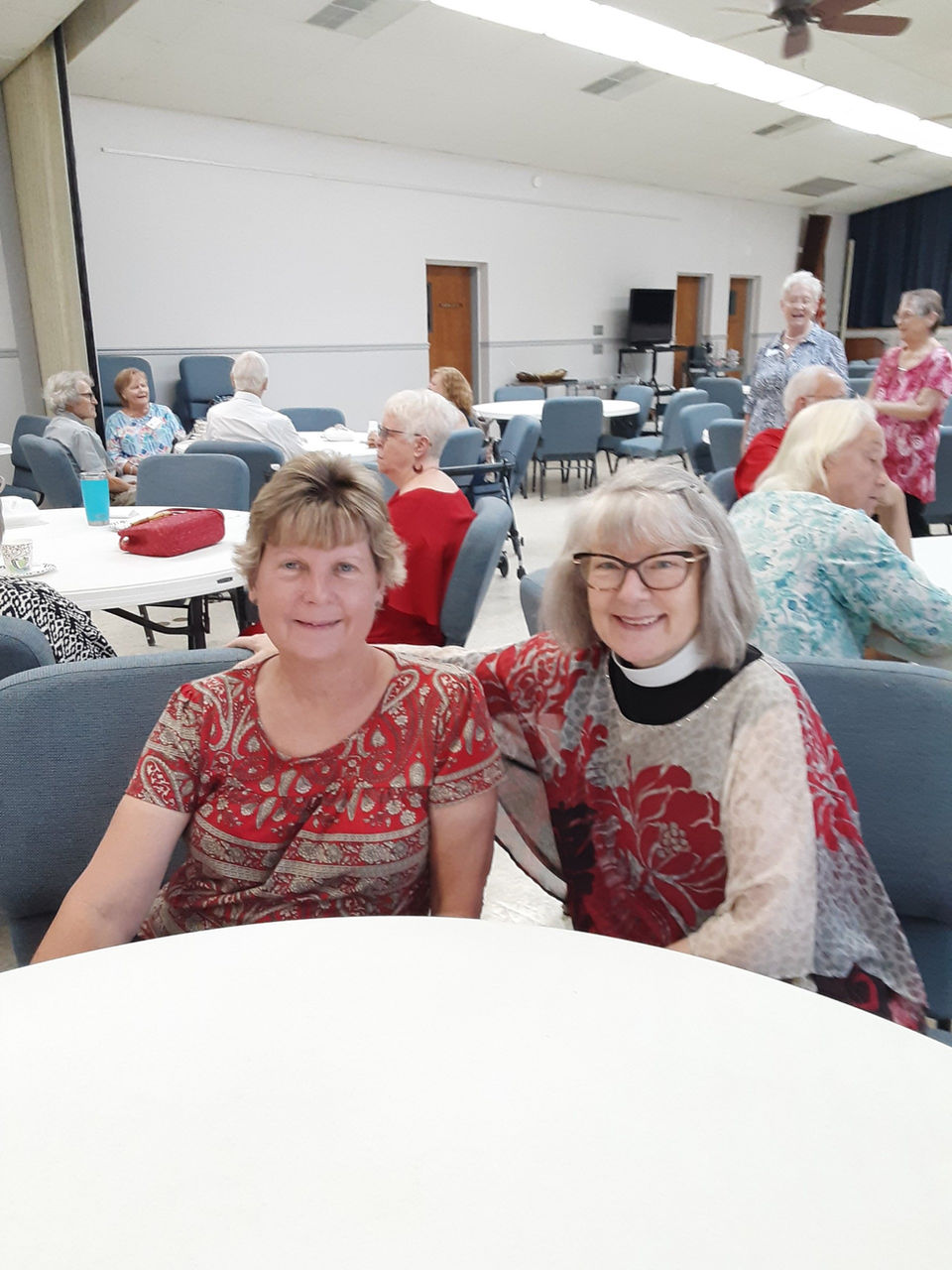 two women smiling at a table