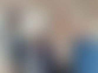 two women and two men standing with arms around each other