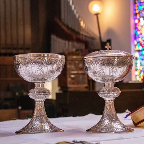 two silver chalices on church altar