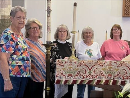 group of women stand behind altar