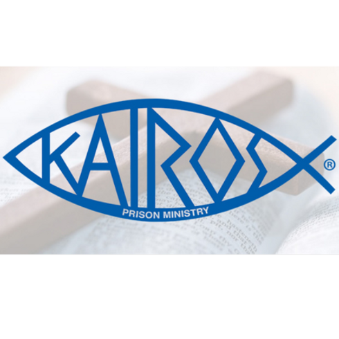 logo for Kairos–blue fish with Kairos written inside in blue over an image of a cross and open Bible