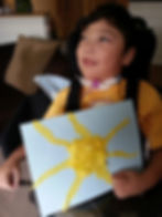 Image of Bret Bigelow holding a picture of the sun.