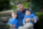 Image of Mark Bigelow, Bret's father, holding two of his sons.