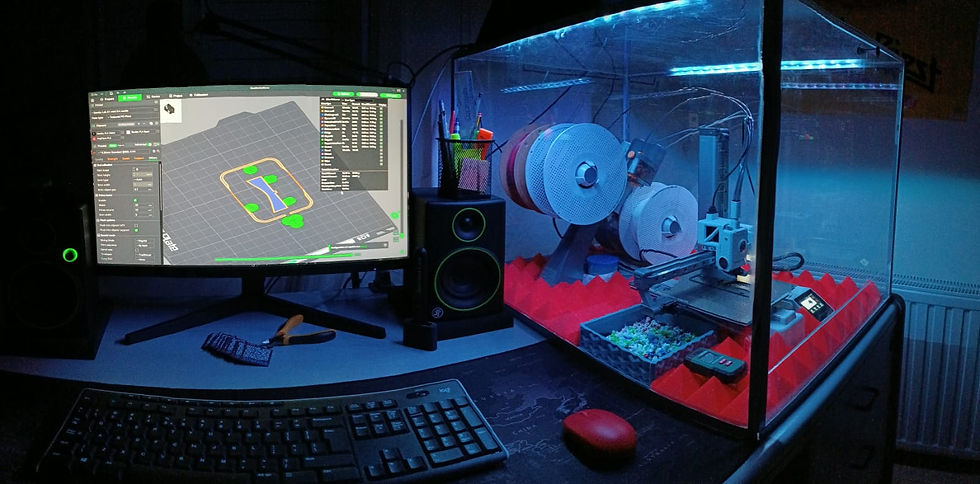 A sleek 3D printing setup, showcasing a computer displaying a 3D model next to a printer with filament spools inside an enclosure, ready for production.