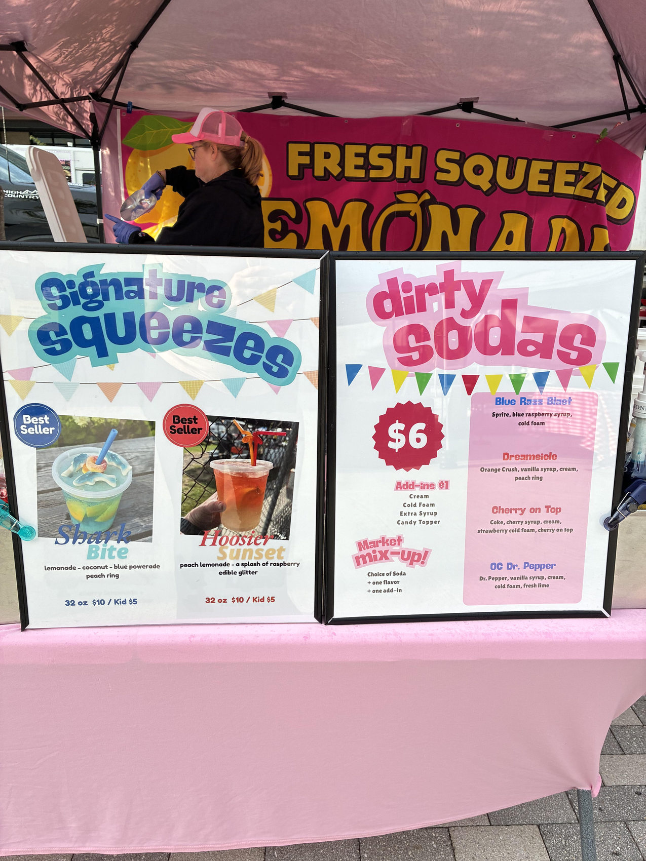 Squeezy Pop dirty soda menu displayed under the pink tent