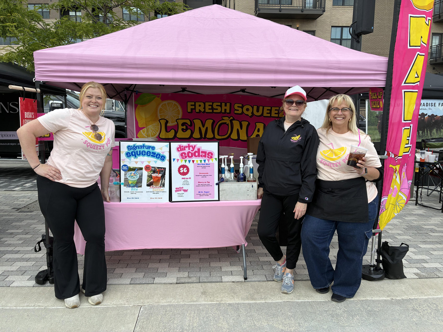 Squeezy Pop team smiling in front of the fresh-squeezed lemonade stand