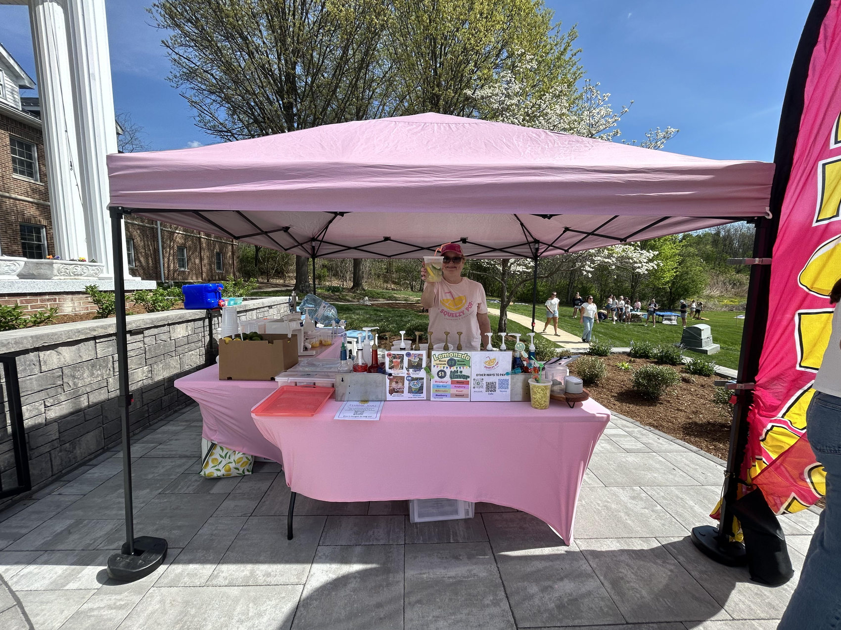 Squeezy Pop bright pink lemonade tent at an outdoor Indiana market