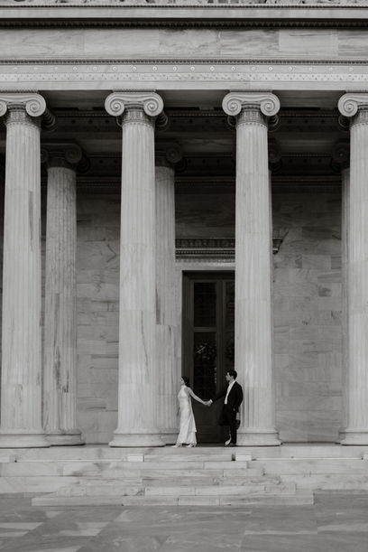 Luxury engagement session in Athens city centre focusing on natural gestures and quiet moments within an architectural setting.