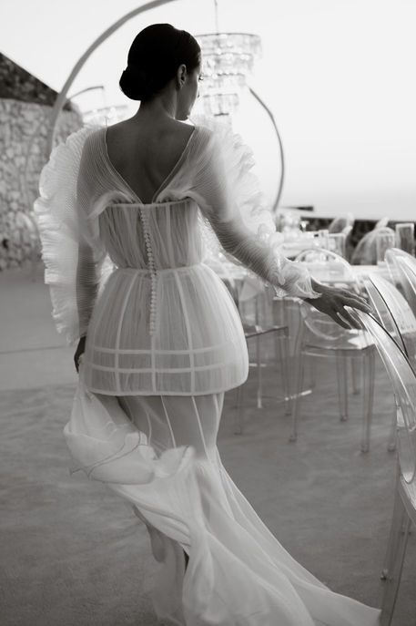 Bride walking through Santorini reception decor setting on her wedding day