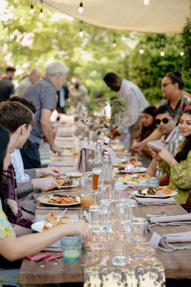 Romantic outdoor dinner setting in Tuscany with string lights and long table design 