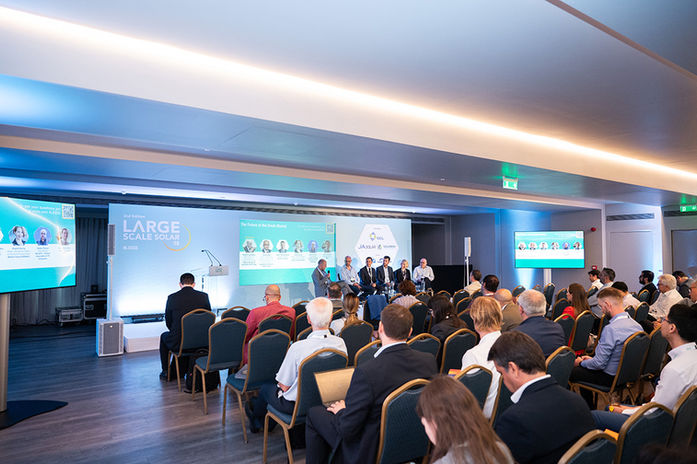 Wide shot of corporate seminar audience listening to keynote speaker in Athens conference hall