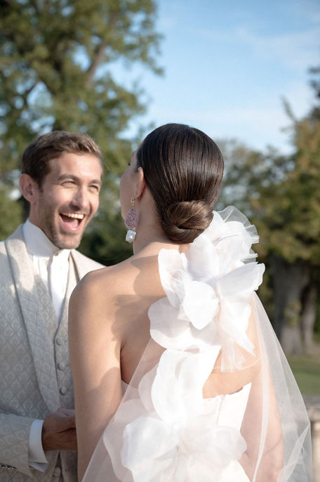 Romantic newlyweds laughing in the gardens of Château de Tourreau