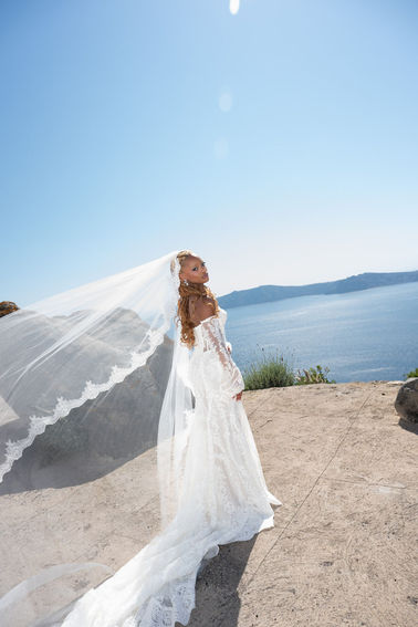 Bride walking through Rocabella Santorini wedding venue