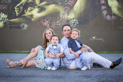 Family session at Wynwood Walls outdoor family session wall painting family sitting on the ground at