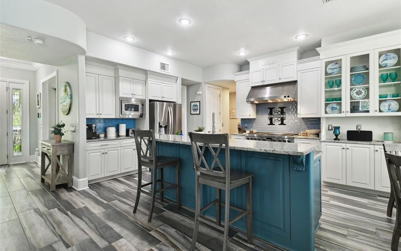 Gourmet kitchen with custom cabinetry, granite countertops, and Wolf gas stove