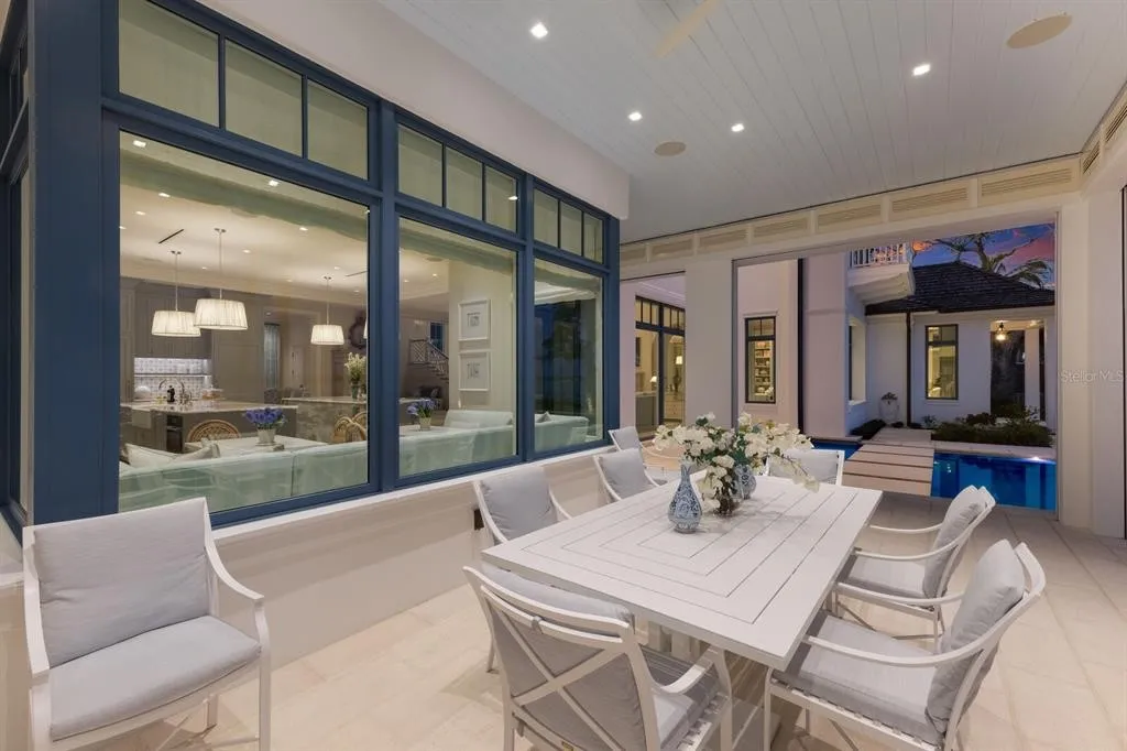 Spacious primary suite with terrace access and serene coastal décor