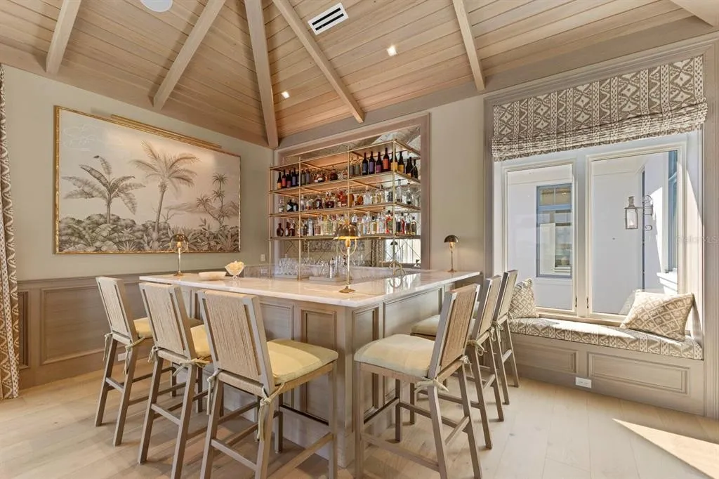 Private infinity-style pool with waterfront views and seating areas