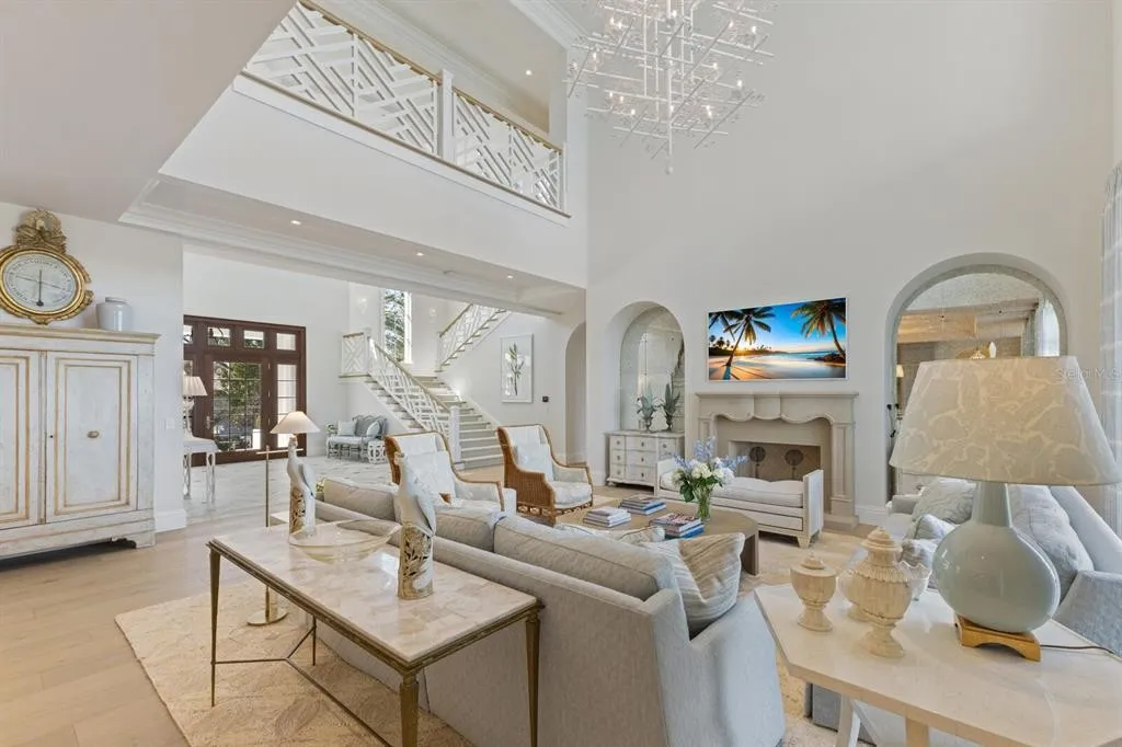 Formal dining area with elegant lighting and water-facing glass doors