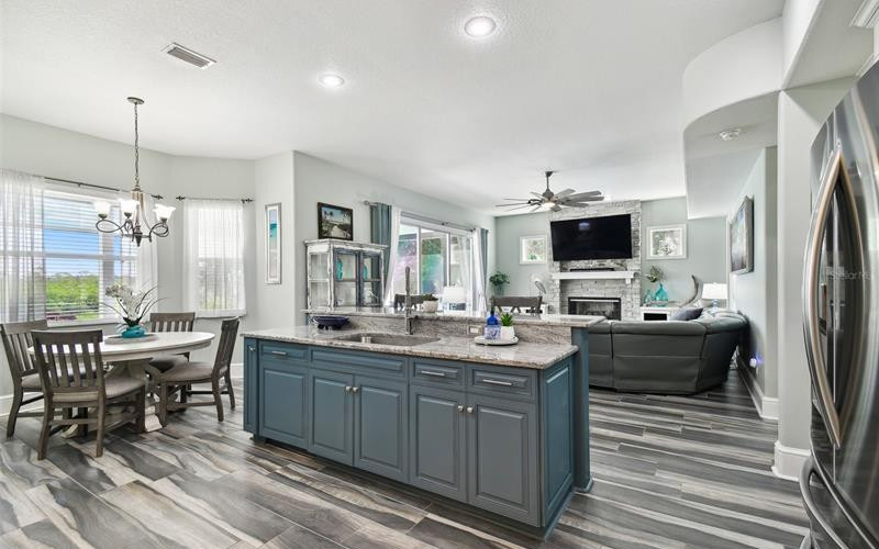 Gourmet kitchen with custom cabinetry, granite countertops, and Wolf gas stove