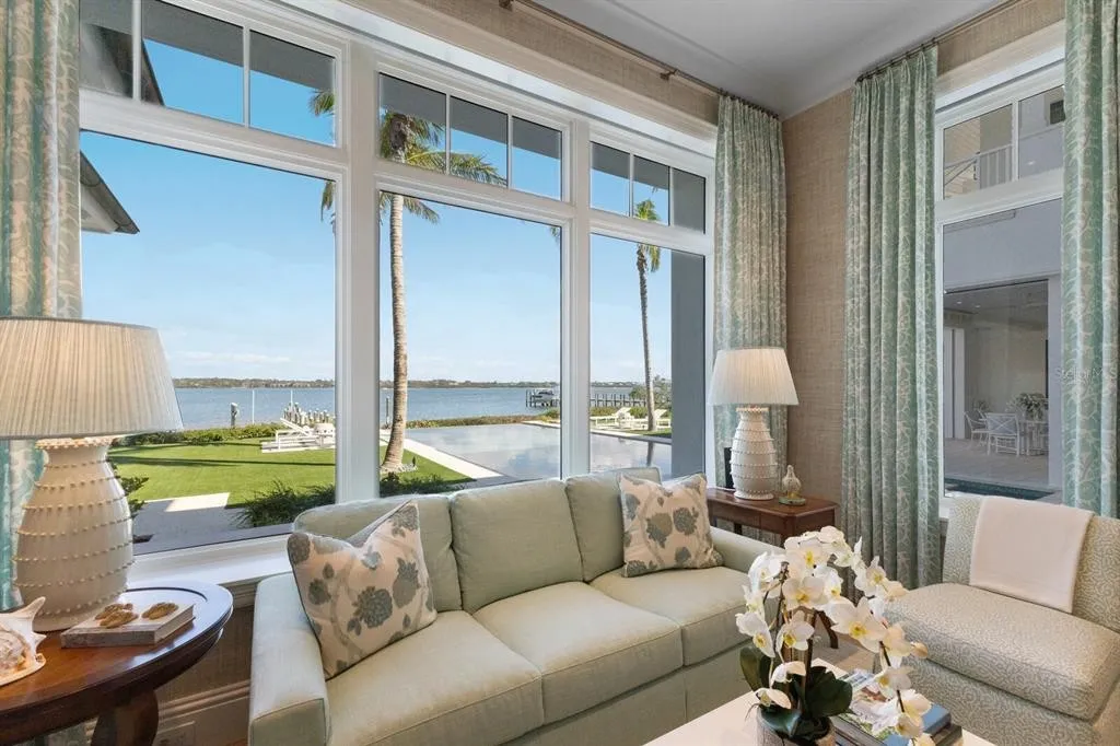 Private tennis court surrounded by lush tropical landscaping