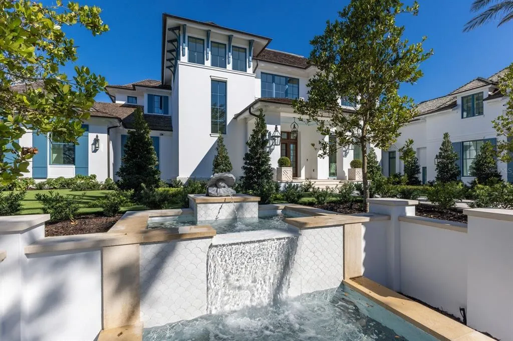 Grand living room with floor-to-ceiling windows and panoramic water views