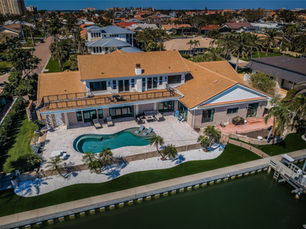 Luxury waterfront home in Bayway Isles, St. Petersburg, featuring a private dock, resort-style pool, and panoramic bay views.