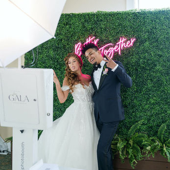 Guests posing at a luxury glam photo booth with professional lighting at an upscale event by Glam Shots Photo 360