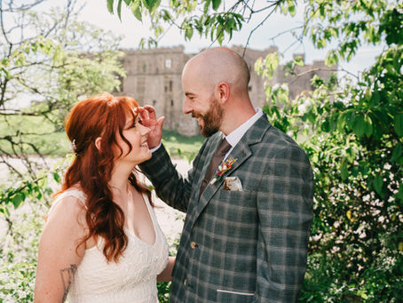 wedding couple looking into each others eyes, at Tenby castle in Pembrokeshire