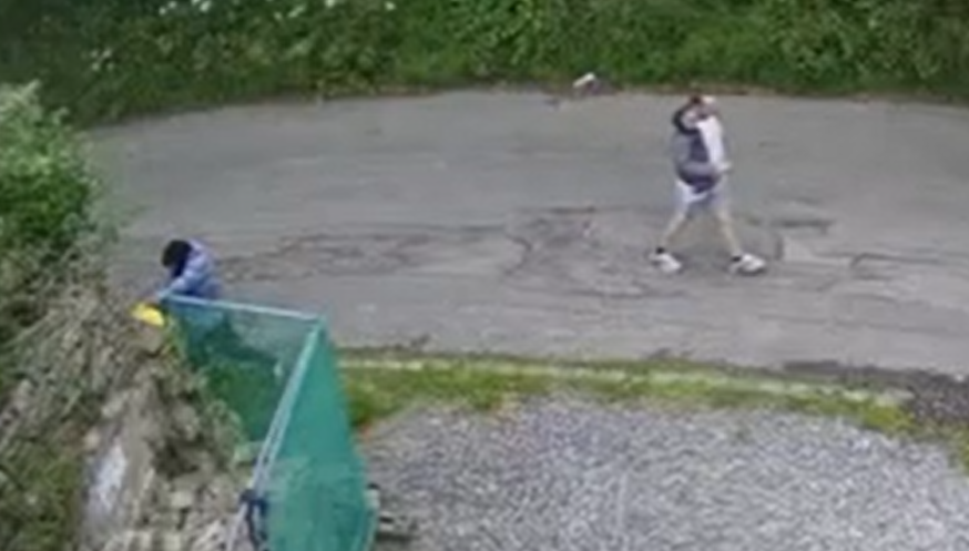 CCTV still showing two individuals walking past the defibrillator cabinet in Fishpool Hill, Brentry shortly before the vandalism occurred.