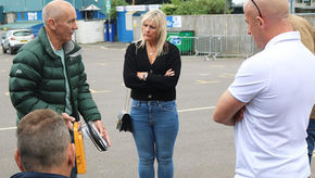 Simon Brookes speaking to a small group about defibrillator use and CPR training.