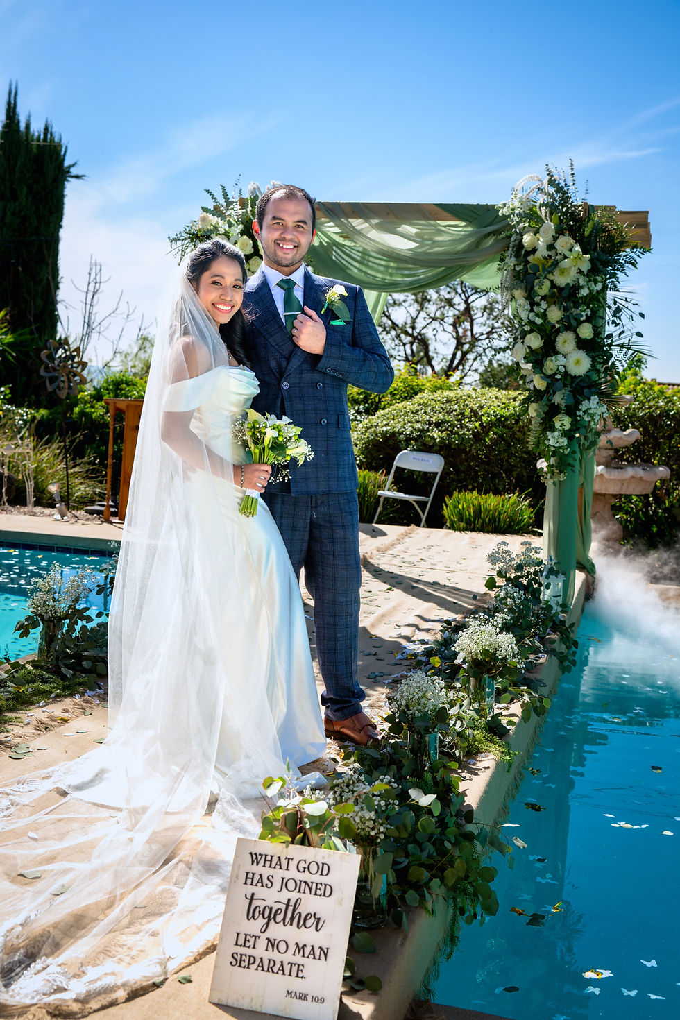Bride and groom by a pool, once a lifetime films.