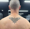 Eagle against a compass back tattoo