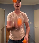 Alex Nelson juggles three balls in mid-air