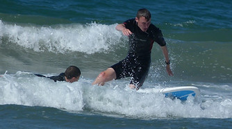 Alex Nelson surfs on a surfboard
