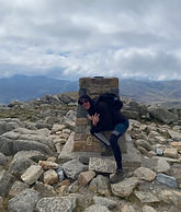 Alex Nelson posing at top of Mount Kosciuzsko