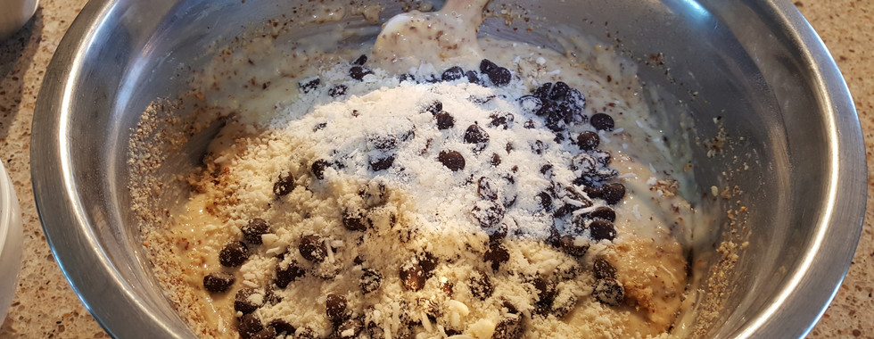 Adding coconut, raisins and chocolate chips to cake mix